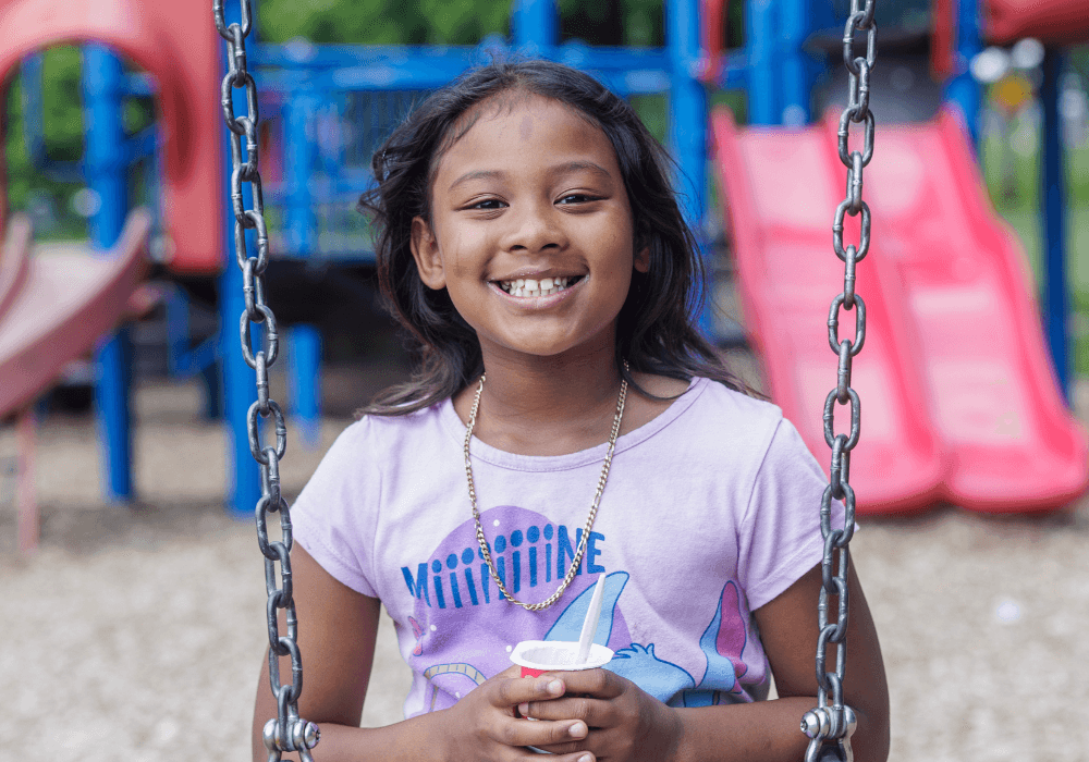 Smiling Littler Girl on a Swing